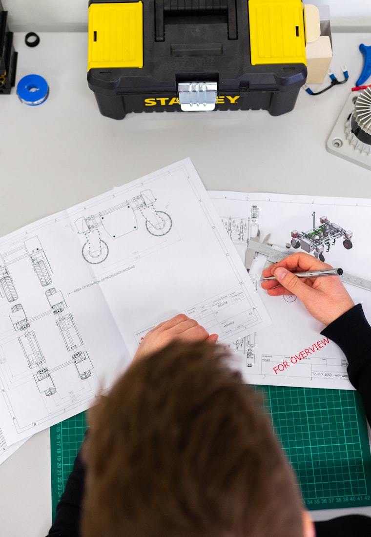 Engineer reviewing technical drawings with callipers