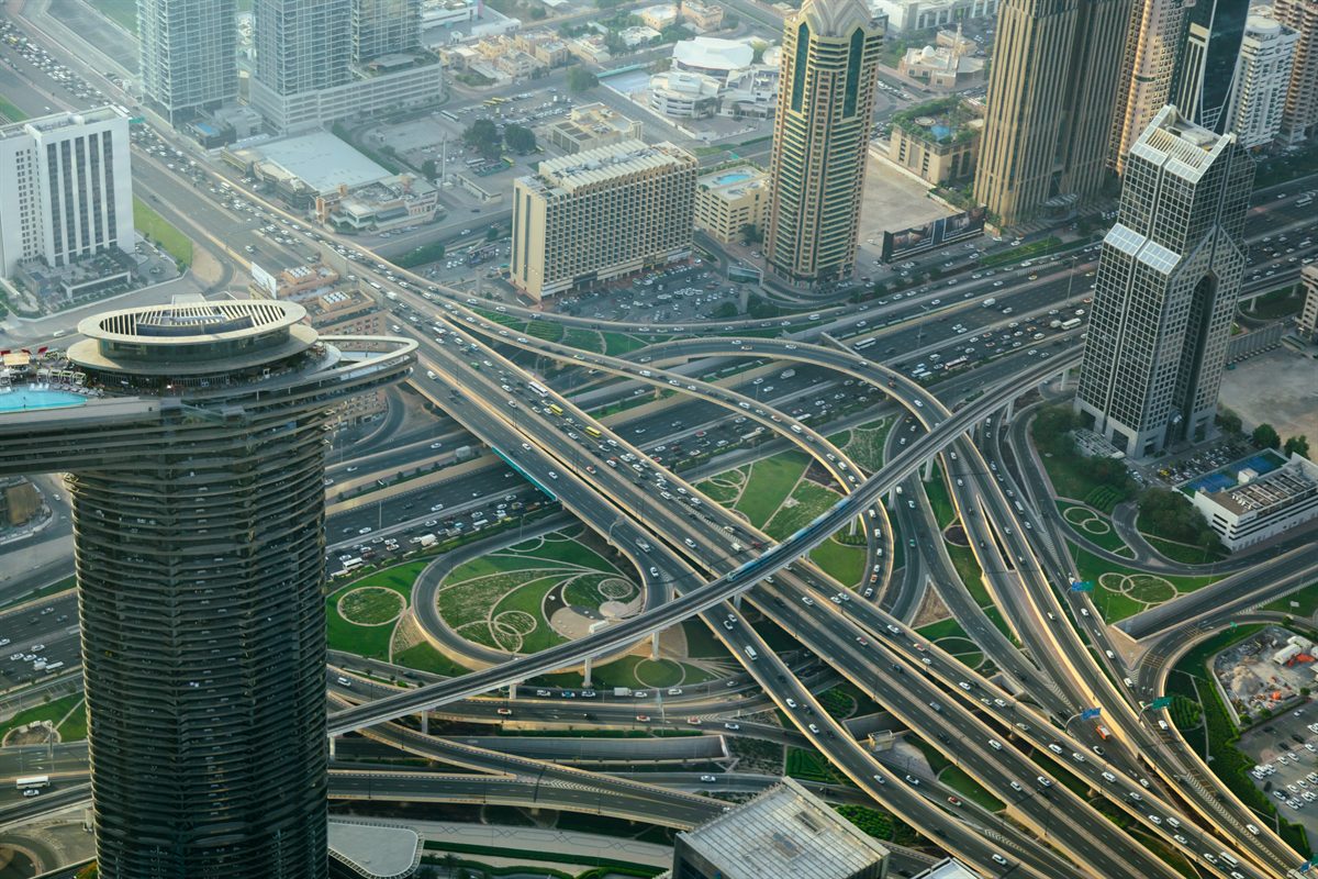 Aerial view of a multi-level highway interchange between city towers